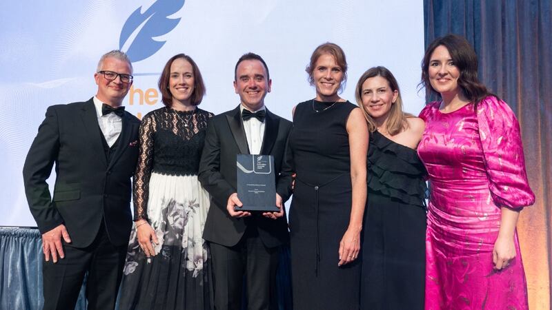 Tomas Finneran, awards judge, presents the overall excellence award to the AIPEC team
