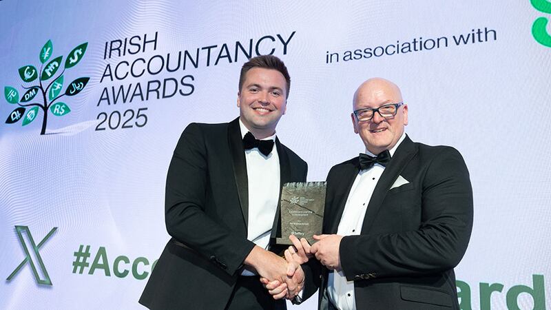 Peter Boyle, director, Saffery, presents the excellence in learning and development award to Gerry Fahy, PAT Business School